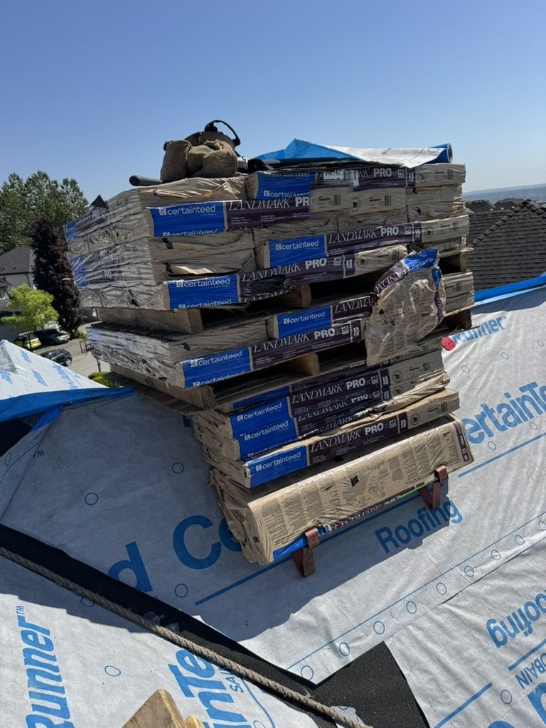 Roofing materials staged on underlayment for installation