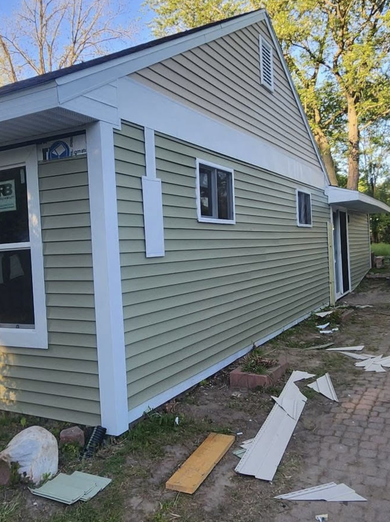Finished siding installation with white trim